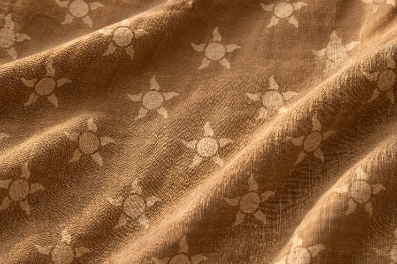 Sun motif faded across folded cloth
